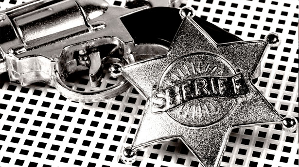 http://freedomwat.ch/wp-content/uploads/2012/09/Pistol-and-sheriffs-badge-via-Shutterstock1.jpg