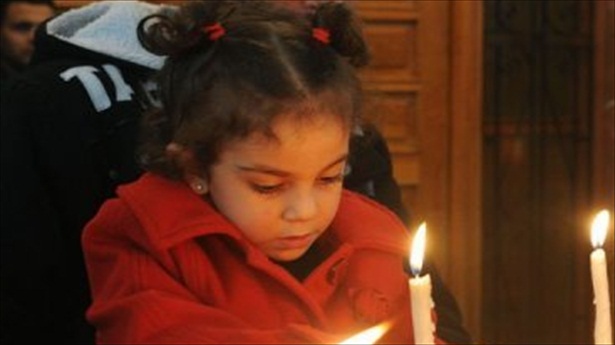 http://freedomwat.ch/wp-content/uploads/2012/12/A-Syrian-girl-lights-a-candle-during-early-Christmas-eve-mass-at-the-Mar-Elias-St.-Elijah-Christian-Orthodox-church-in-Bab-Tuma.-Photo-via-AFP.1.jpg